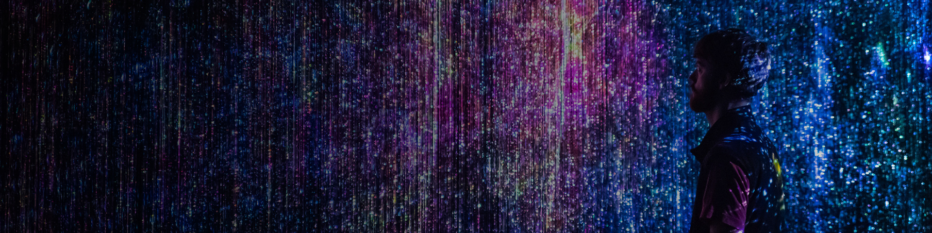 Man standing amongst an abstract background of lights
