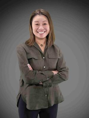 Ann standing in front of a dark background
